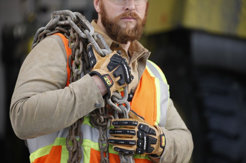 Image of worker using the Mechanix Wear Leather M-Pact Driver F9-360 gloves.