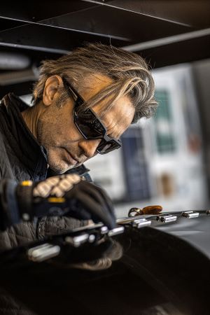 Image of mechanic wearing Mechanix Wear safety eyewear.